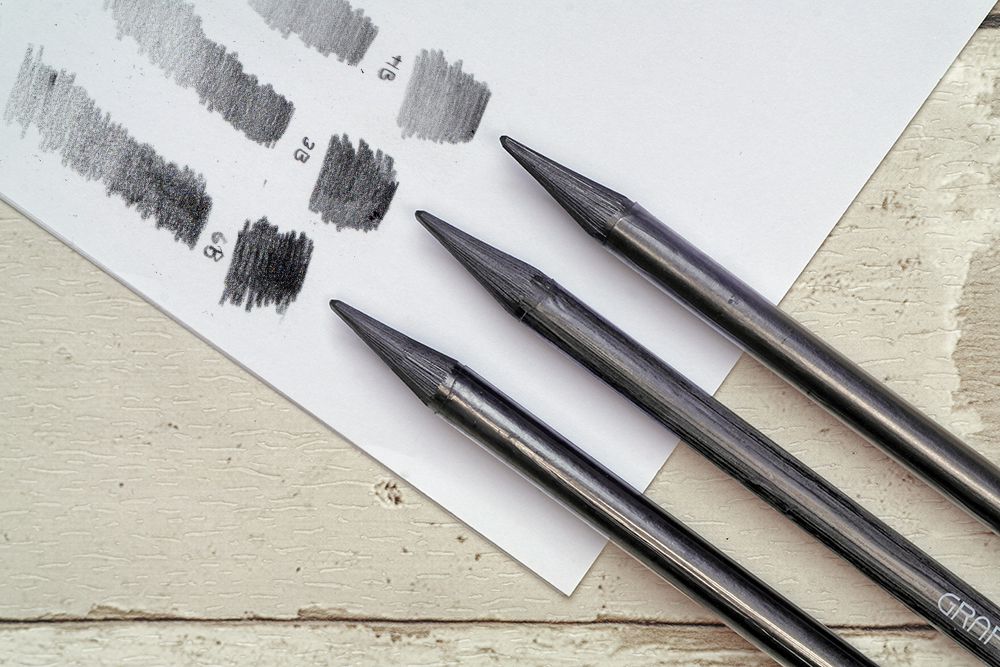 The full range of Caran d'Ache Grafstone Graphite drawing and sketching pencils with swatches