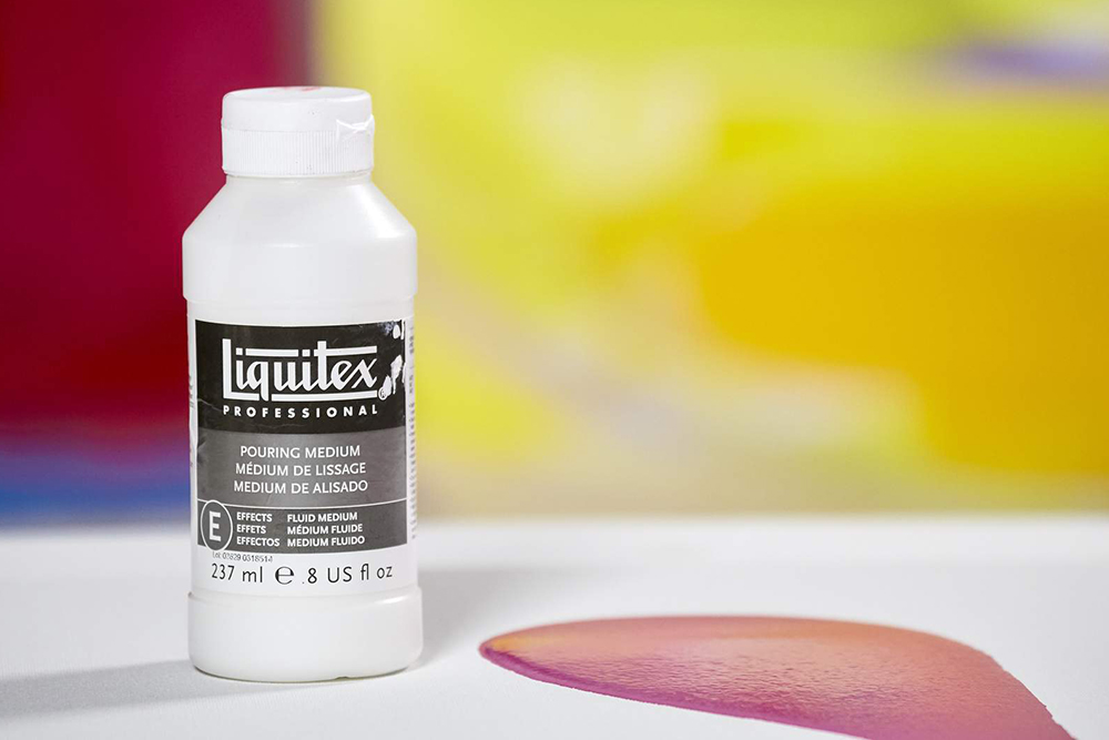 A bottle of Liquitex Pouring Medium and a puddle of poured acrylic paint