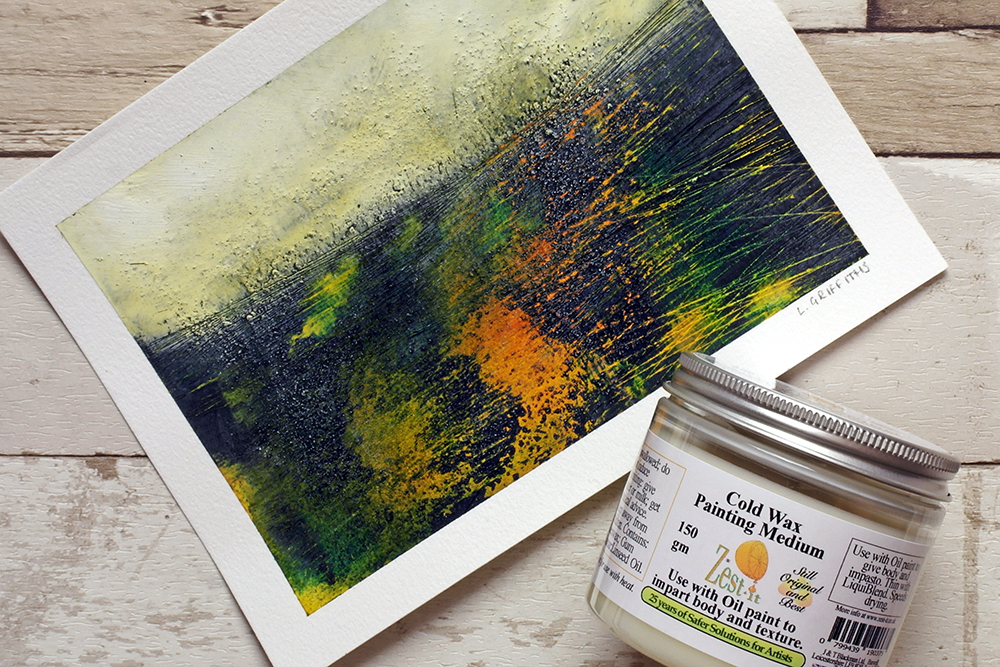 A cold wax painting using oil and cold wax medium by Liz Griffiths on a pale wooden background with a jar of cold wax painting medium