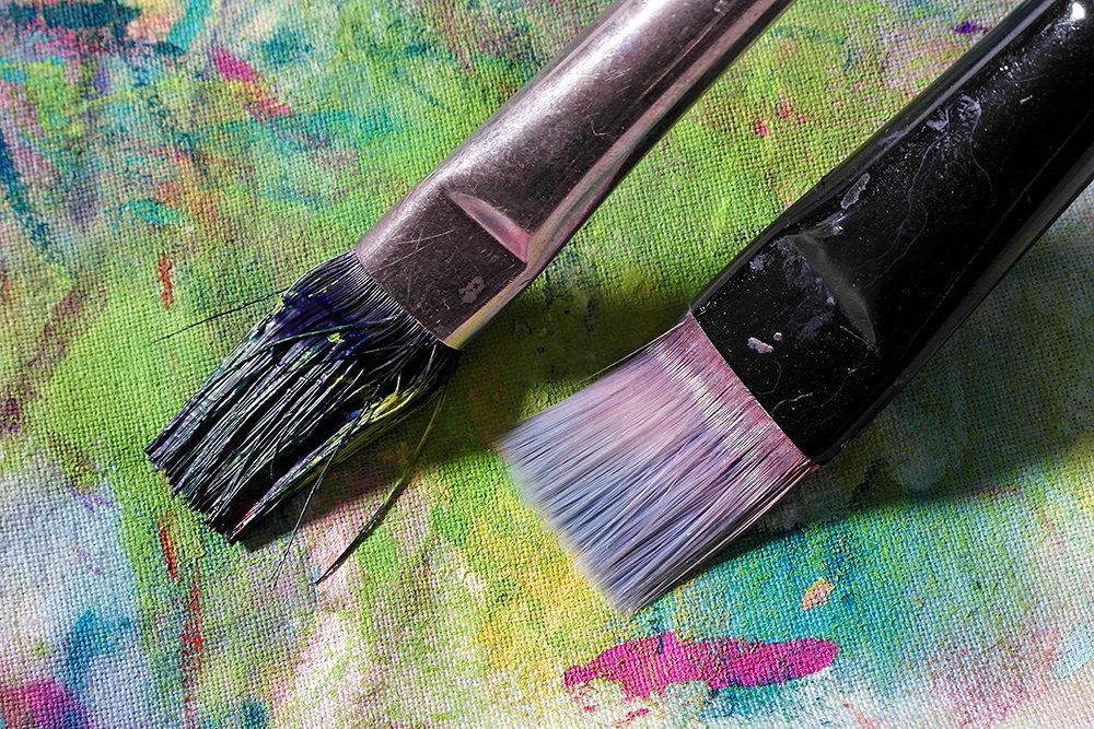 A clean paint brush and another clogged with acrylic paint compared