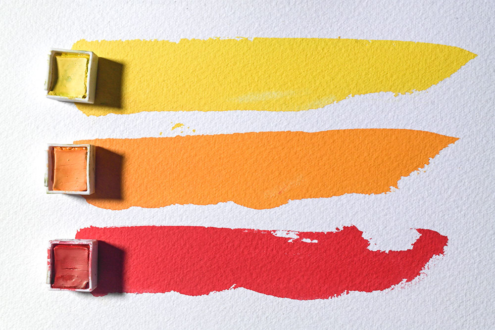 Strokes made with concentrated mixes of Sun Yellow (top), Mango (middle) and Poppy Red (bottom).