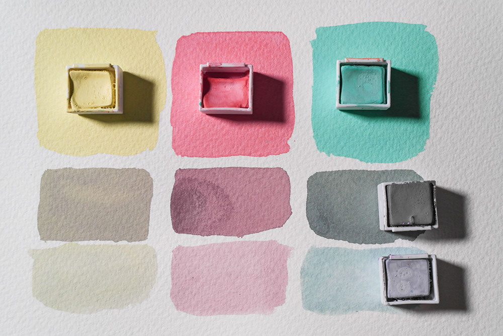 Swatches of Lemon, Pink Flamingo and Mint line the top of the photo. Below the same colours are mixed with Storm Grey and Silver blue to create tones and shades.