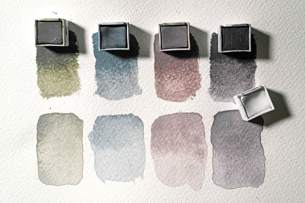 Swatches of Derwent Tinted Charcoal in Dark Moss, Mountain Blue, Glowing Embers and Thistle used alone. A swatch below shows the same colours but mixed with White.