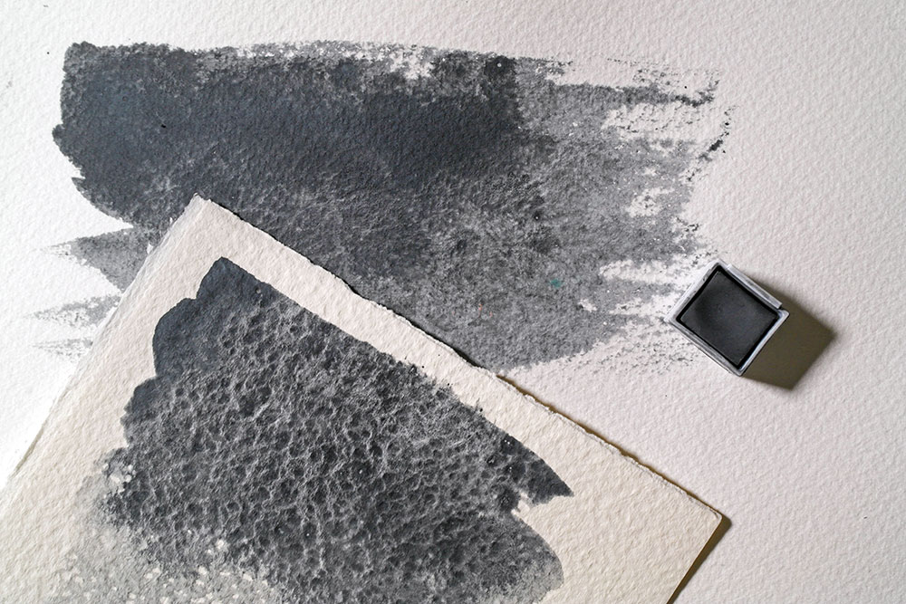 Swatches of Derwent Tinted Charcoal Ocean Deep painted on both NOT (Cold Pressed) and Rough watercolour paper.