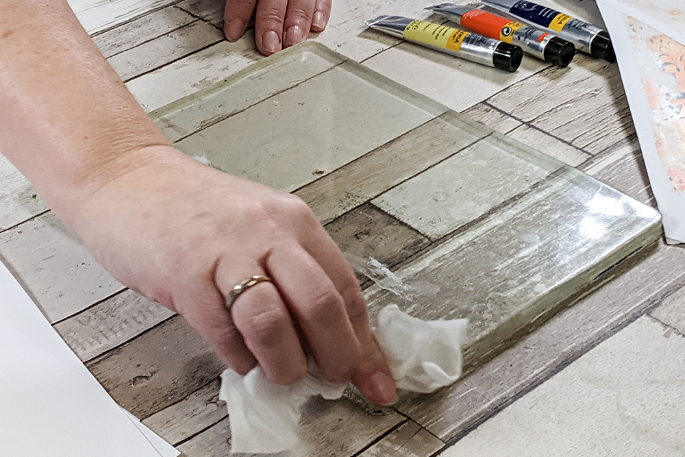 Cleaning and Maintaining your Gel Plate - a gel plate being cleaned with a baby wipe.