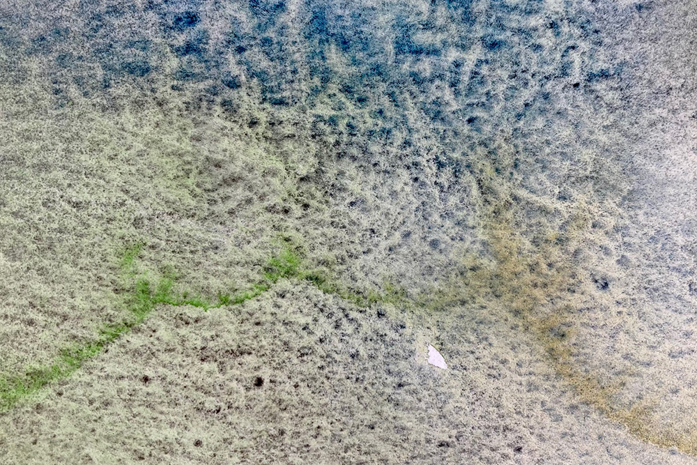 Photo demonstrating granulation in watercolour paint with green and blue watercolours.