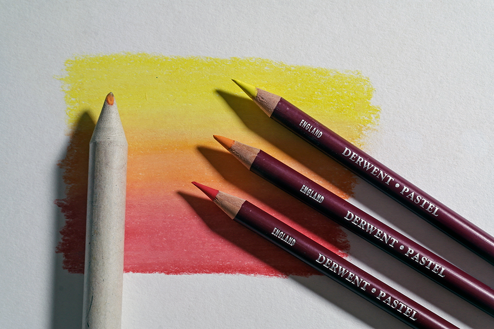 Create smooth transitions of colour with blending tools - Derwent Pastel Pencils in Yellow, Orange and Red have been used to create a smooth gradient between the three colours.