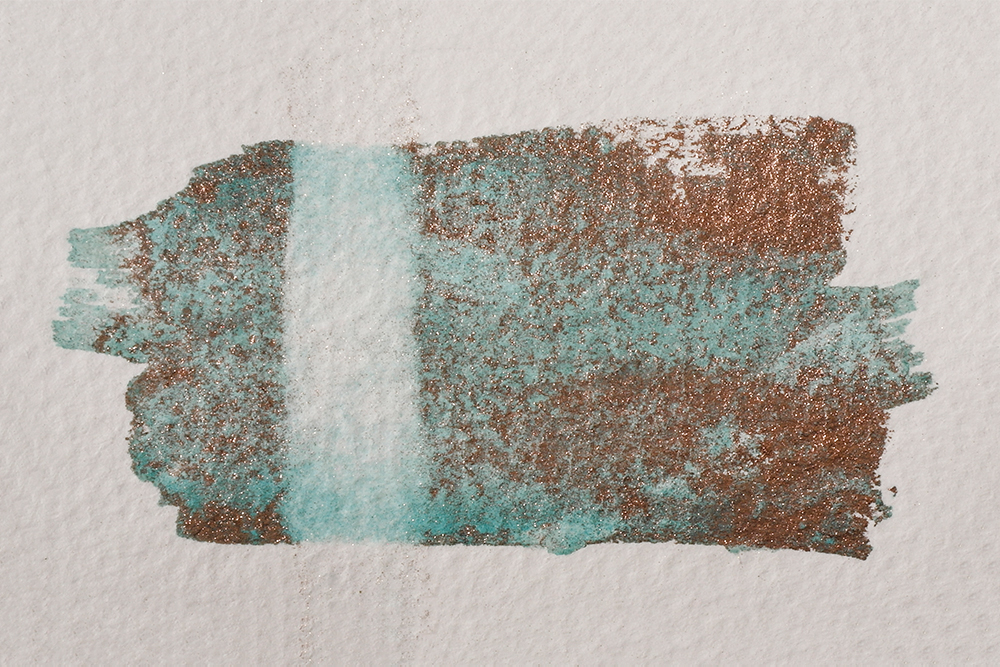 Swatch of Aqua Bronze mixed with watercolour and a line shown where it has been rewetted.