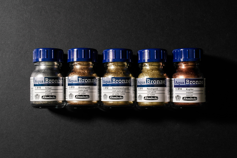 Image of the five different colours of Aqua Bronze in their jars.