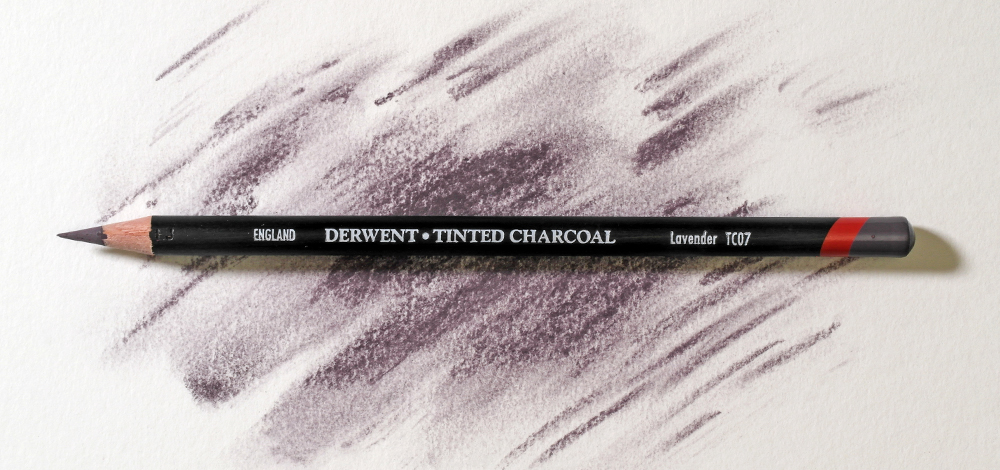 Derwent Tinted Charcoal Powder Based Coloured Pencil on a colourful background
