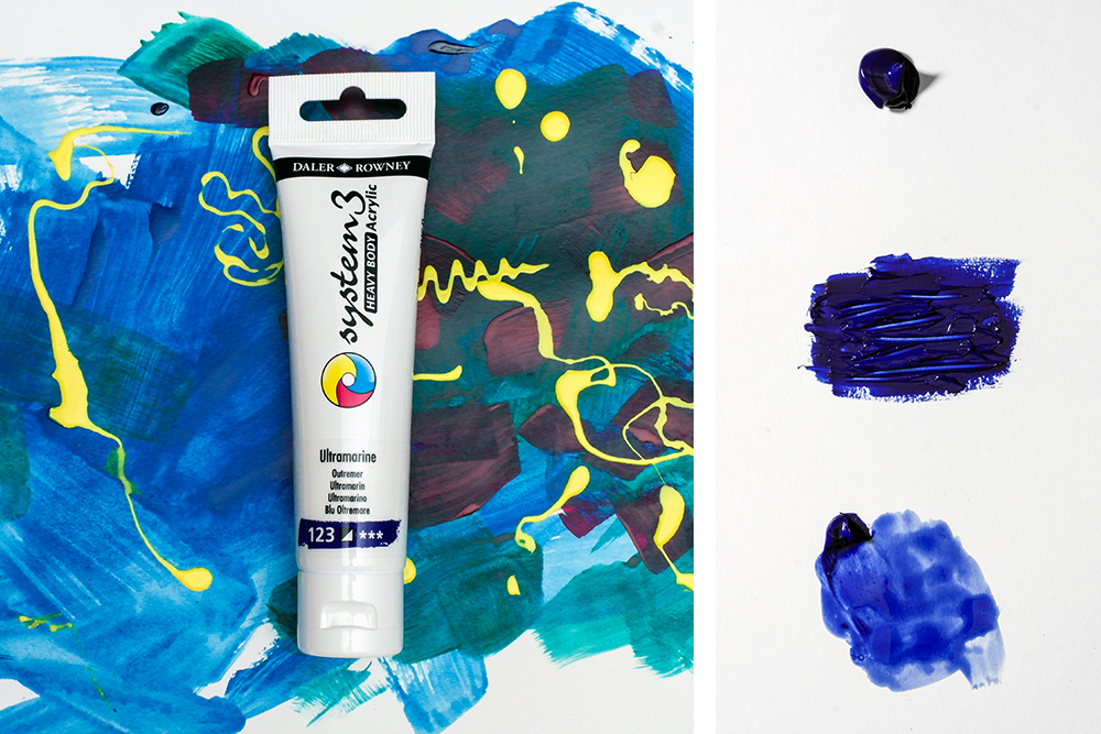 A photograph of System 3 Heavy Body Acrylic Paint on a colourful painted background alongside a dripped sample showing viscosity.