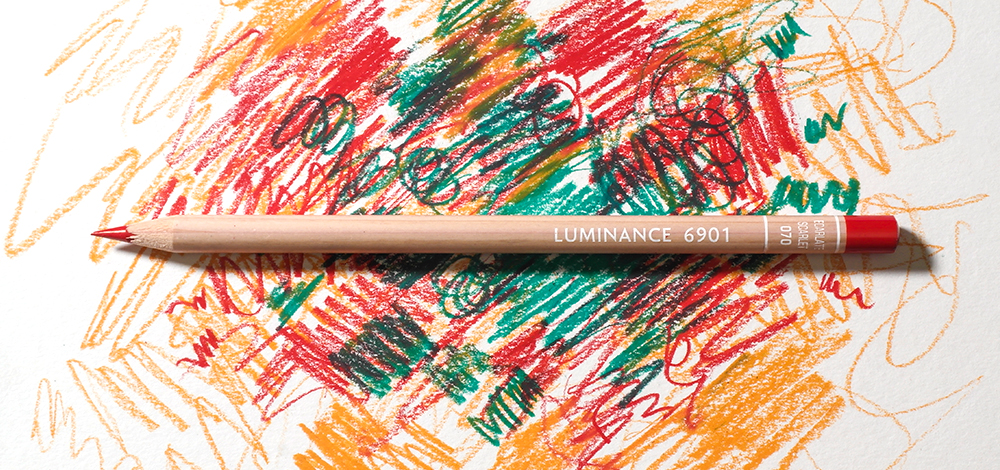Cran d'Ache Luminance 6901 Oil Based Coloured Pencil on a colourful background