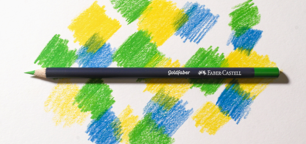 Faber-Castell Goldfaber Wax Based Coloured Pencil on a colourful background