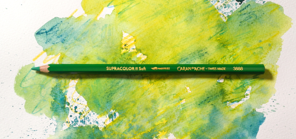 Caran d'Ache Supracolor II Soft Wax Based Watercolour Pencil on a colourful background