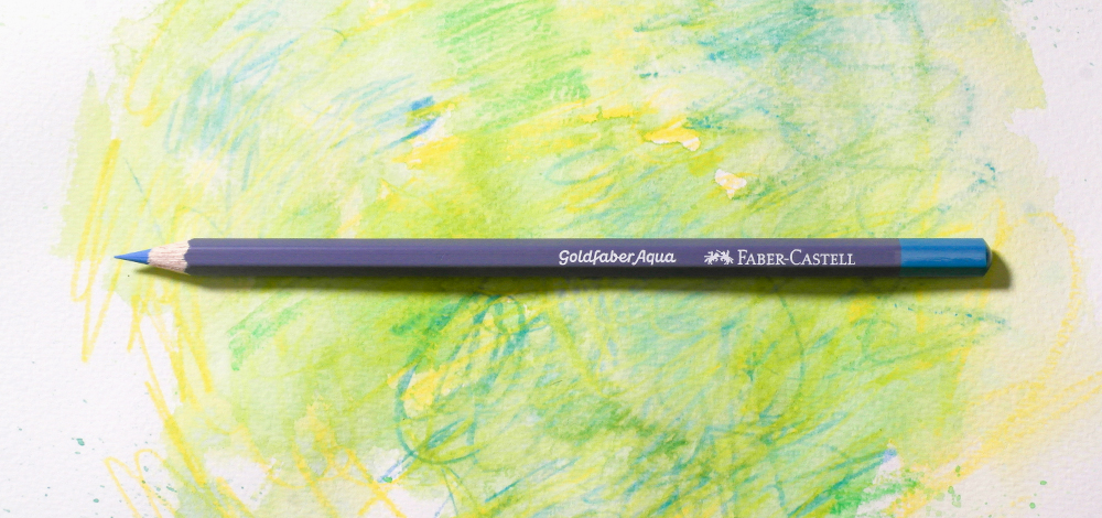 Faber-Castell Goldfaber Aqua Wax Based Watercolour Pencil on a colourful background