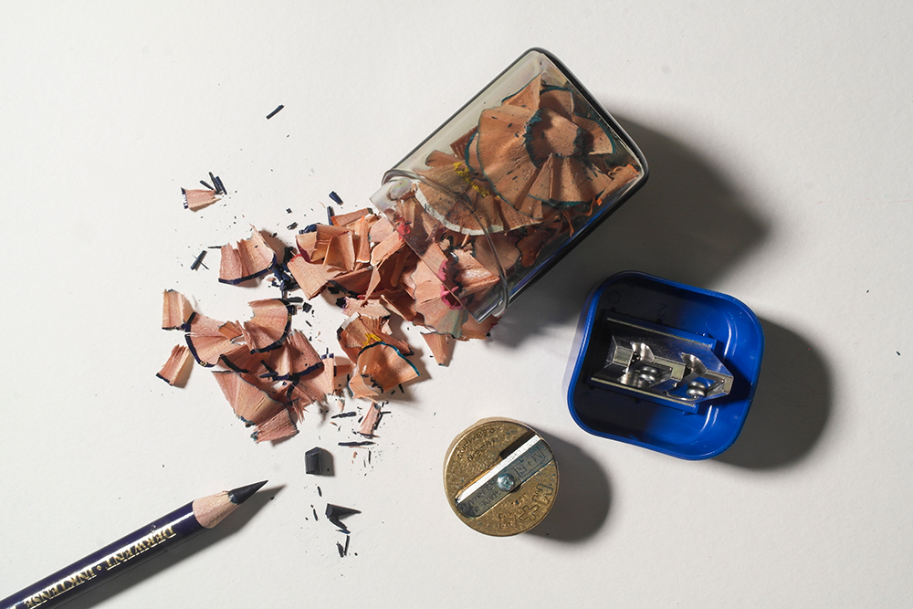 Canister and simple manual pencil sharpeners with shavings and a pencil