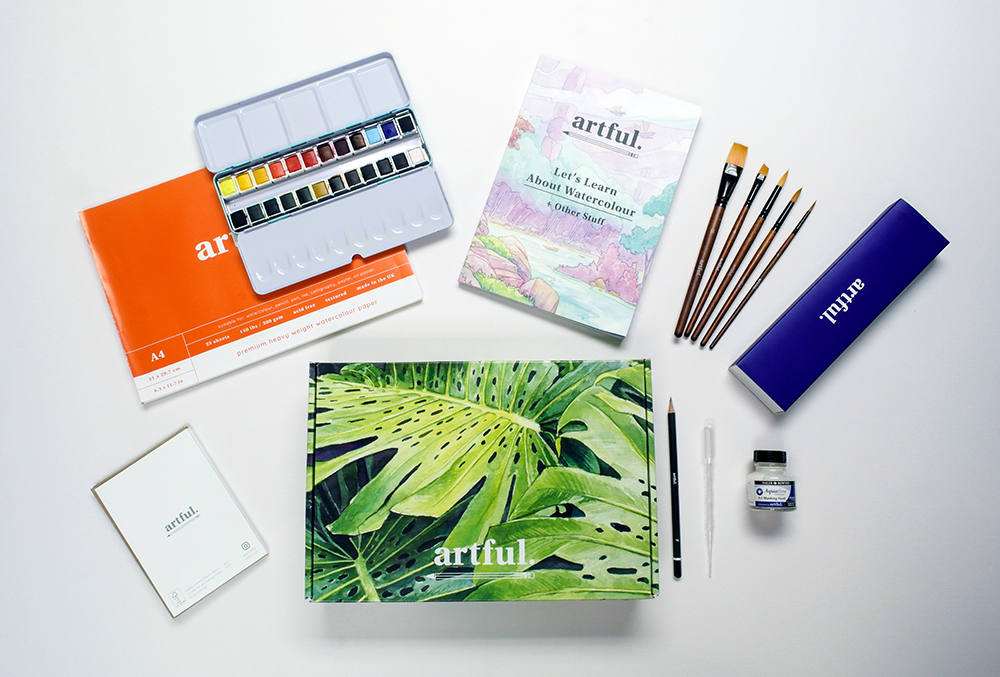 Flatlay of materials included in the Artful Let's Learn Watercolour Box Set