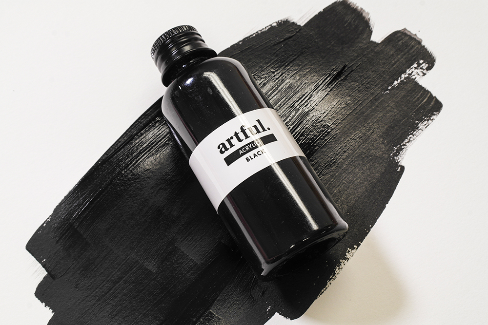 A bottle of black Acrylic Paint from the Artful Lets Learn Clay Sculpture Starter Box