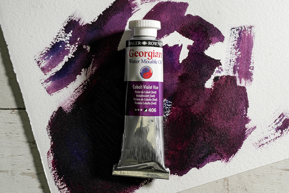 A tube of Daler-Rowney Georgian Water Mixable Oil on a painted background.