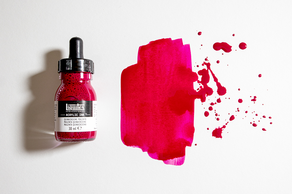 A bottle of Liquitex Professional Acrylic Ink with a splattered swatch of colour