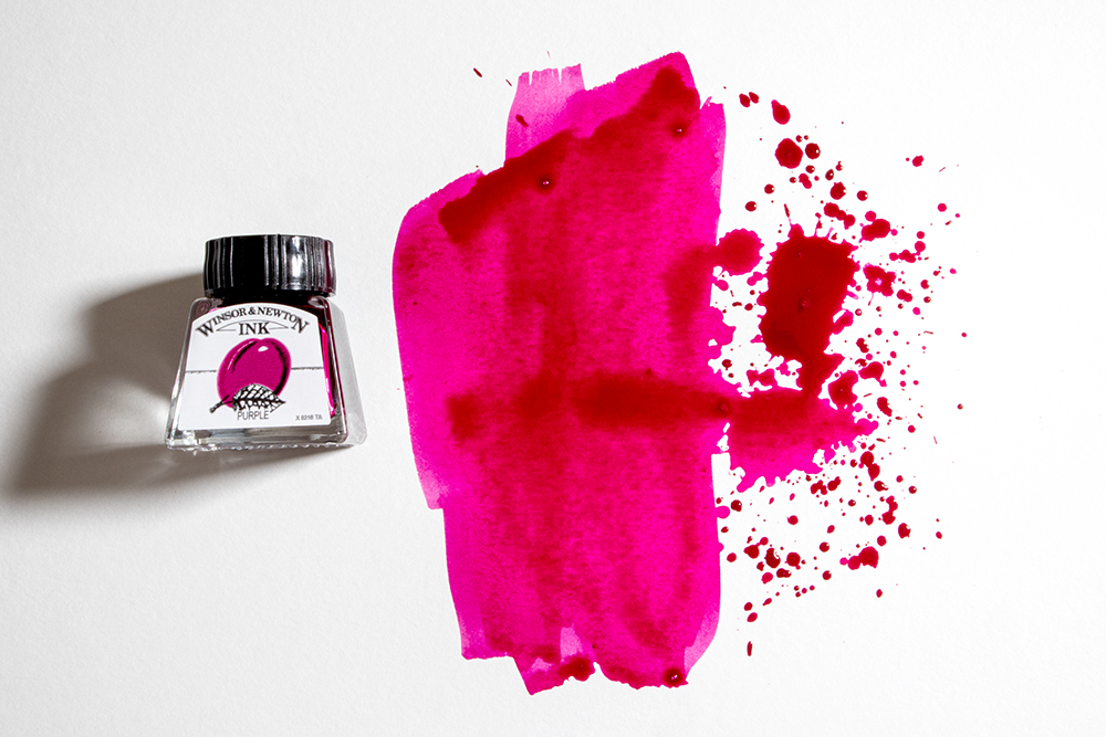 A bottle of Winsor & Newton Drawing Ink with a splattered swatch of colour