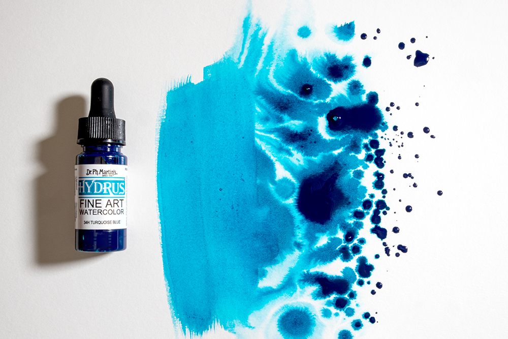 A bottle of Dr Ph Martin Hydrus Liquid Watercolour Ink with a splattered swatch of colour