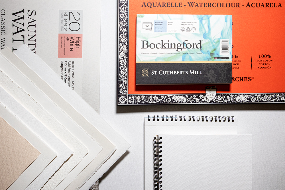 A group of watercolour papers in blocks loose sheets and pads of various sizes