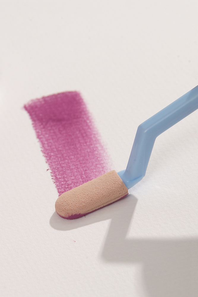 Artist using a Sofft Knife to apply a stroke of magenta PanPastel soft pastel